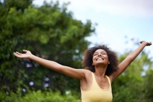 Shot of a young attractive woman being joyous in the outdoors