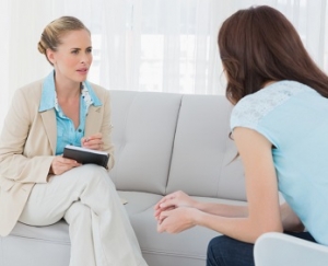 Attentive psychologist having session with her patient in her private consulting room