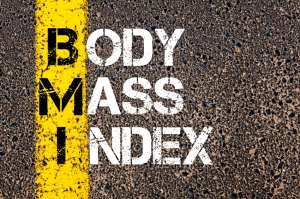 Acronym BMI - Body Mass Index. Conceptual image with yellow paint line on the road over asphalt stone background.