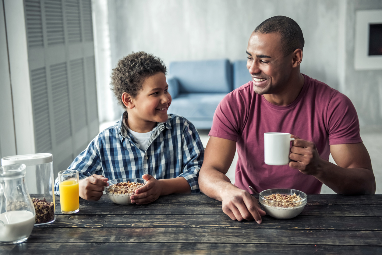 father and son having breakfast